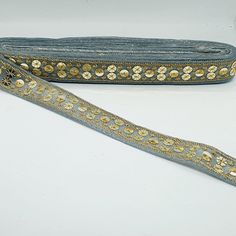 a pair of blue and gold beaded purses on a white surface with one bag in the foreground