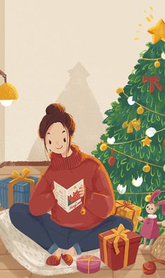 a woman sitting in front of a christmas tree while reading a book and listening to headphones