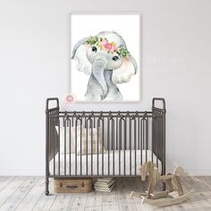 an elephant with flowers on its head in a baby's room next to a crib