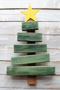 a christmas tree made out of wooden planks on top of a white wood wall