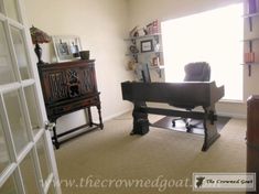 a living room filled with furniture and a piano