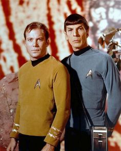 two men standing next to each other in star trek uniforms