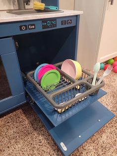 the dishwasher is full of colorful dishes