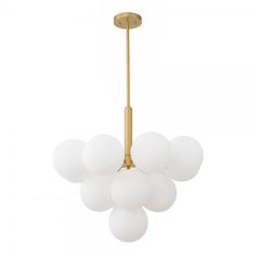 a brass chandelier with five white glass balls hanging from the bottom and one light fixture