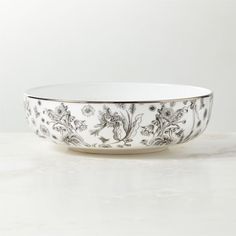 a white and black bowl sitting on top of a table