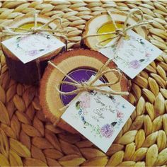 three pieces of wood sitting on top of a woven table cloth with tags attached to them