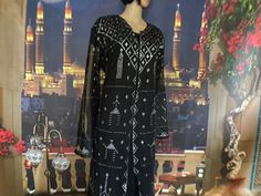 Here we are thrilled to present this ridiculously shiny black Egyptian Assuit open robe or cover-up. Check out the jeweled collar with dramatic silver that almost glows with every move. It has belled  sleeves and many dramatic pillars of candles all over the robe, front and back.  The bottom of the robe and the end of the sleeves have filled pyramids to show off your lovely hand and foot movements. These are so pretty, you can toss them over some leggings and tank and wear them to clubs, half's, parties, beach cover ups and more. Popular at burning man too. Bellydancers deluxe costume covers always steal the show. More importantly, each silver thread is stitch by hand by one of the women in our fair trade group, so you are practicing cultural appreciation when you purchase here. We dont st Black Bollywood Kaftan For Party, Bollywood Black Kaftan For Party, Bohemian Abaya For Festive Parties, Festive Bohemian Abaya For Party, Bohemian Style Festive Party Abaya, Festive Bohemian Party Abaya, Black Festive Kaftan For Festivals, Black Kaftan For Festivals, Black Kaftan For Festive Occasions And Festivals