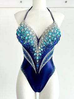 a mannequin wearing a blue and silver bodysuit with sequins on it