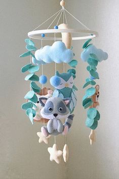 a baby crib mobile with stuffed animals hanging from it