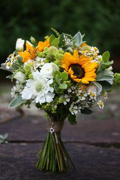 a bouquet of sunflowers and other flowers on a table