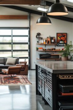 a kitchen with an island in the middle and lots of lights hanging from the ceiling