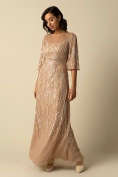 Beige gown embroidered with beads and sequin in linear pattern. - Aza Fashions Sequined Floor-length Mother Of The Bride Dress, Elegant Sequined Evening Dress For Reception, Elegant Sequined Gown For Reception, Floor-length Sequin Gown For Mother Of The Bride, Luxury Sequined Mother Of The Bride Evening Dress, Festive Sequined Dress For Mother Of The Bride, Mother Of The Bride Sequined Gown With Fitted Bodice, Mother Of The Bride Festive Sequin Dress, Elegant Floor-length Hand Embellished Sequin Dress