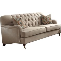 an image of a couch with pillows on the arm and back cushions in different colors