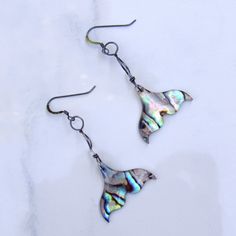 Mermaid Tail abalone shell Earrings on Oxidized Sterling Silver We do our best to choose each stone carefully and purposefully for every piece.. However there might be slight differences in color size shape and clarity which makes each item unique and one of a kind.Each piece of jewelry will come in a colored drawstring bag for it’s protection and storage or to be ready to give as a gift.Our gemstone jewelry are all original designs by Lisa Beth and LDE Affinity Jewelry. They are hand crafted wi Iridescent Mother Of Pearl Dangle Jewelry, Unique Silver Shell Earrings, Iridescent Mother Of Pearl Jewelry With Matching Earrings, Unique Nickel-free Shell-shaped Earrings, Iridescent Mother Of Pearl Earrings, Iridescent Mother Of Pearl Drop Earrings, Handmade Iridescent Shell Jewelry, Iridescent Abalone Shell Nickel-free Earrings, Iridescent Nickel-free Abalone Shell Earrings