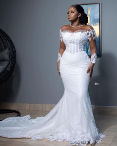 a woman in a white wedding dress posing for the camera