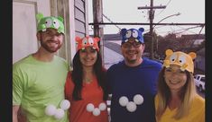 a group of people standing next to each other wearing mickey mouse ears on their heads