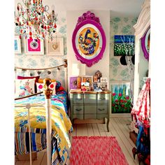 a bed room with a neatly made bed next to a dresser and paintings on the wall