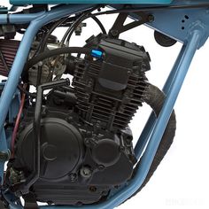 an image of a motorcycle engine on the back end of it's carb