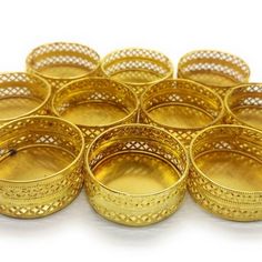 many gold colored metal containers on a white surface