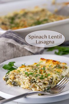 spinach lentil lasagna on a white plate with a fork next to it