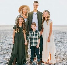 a family poses for a photo on the beach