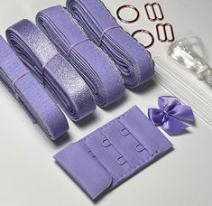 several pieces of purple cloth with ribbons and scissors