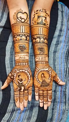 two hands with henna designs on them