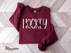 As the mom of a hockey player, you know exactly how the game can take over – your child’s passion for their team and the sport can feel endless. Which is why this sweatshirt featuring the iconic saying “Hockey Mom” is a must have. We love it because of its thick, cozy fabric, great fit, and minimalist graphic that spells Hockey with the words Mom spelled out on top of the word Hockey. The letter 0 graphic in Mom is a hockey puck – what could be better? ▬▬▬▬▬▬▬▬▬▬▬▬▬▬▬ Hockey Mom Outfit Style, Field Hockey Mom Shirts, Hockey Aunt Shirt, Hockey Mom Shirts Cricut, Hockey Mom Sweatshirt, Women Hockey, Hockey Sweatshirts Design, Hockey Mom Gifts, Highland Cow Gifts