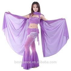 a woman in purple belly dance costume posing for the camera with her hands on her hips