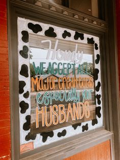 a sign in a window that says we accept art music crafting especially your husbands