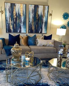 a living room filled with furniture and blue pillows on top of it's covers