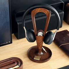 a wooden headphone stand on top of a desk