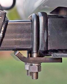 the front end of a vehicle with its brake levers down and two bolts on it