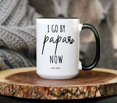 a black and white coffee mug with the words i go by papa now on it