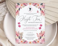 an elegant floral tea party with pink roses and white paper napkins on a plate