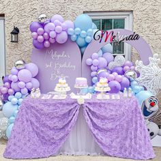 a purple and blue dessert table with balloons