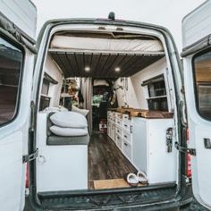 the interior of a camper van with its door open and storage area in place