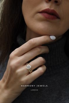 a close up of a person wearing a ring with a diamond on it's finger