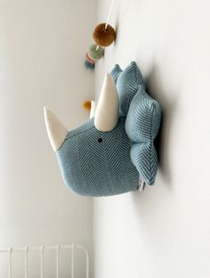 a stuffed animal is hanging on the wall