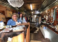 two women are standing at the counter in a store