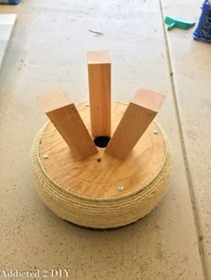 a wooden object sitting on top of a floor