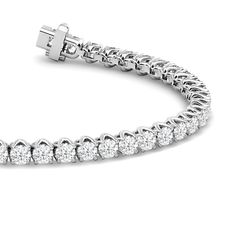 A tennis bracelet displaying a pared-back yet bold aesthetic. This piece features a continuous line of round diamonds set in a decorative tulip basket. This sparkly and elegant piece comes with that little bit of extra style to distinguish itself from the rest. Luxury Formal Hallmarked Tennis Bracelet, Tennis Bracelet Aesthetic, Tenis Bracelet, Tulip Basket, Mothers Day Rings, Bold Aesthetic, Diamond Pendants Designs, Round Diamond Setting, Bracelet Diamond