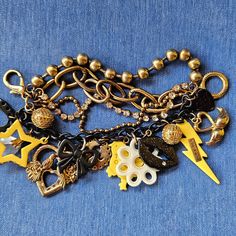 Description: Size: Approx. 7" - 7.5" Rare Hard To Find Chunky Rocker Chick Charm Bracelet By Bj. Bracelet W/2 Gold-Tone Mesh Balls; Black Circle Charm W/Cut-Out Heart & Xox Engraved; Large Plastic/Acrylic Clear-Stone Bauble; Yellow Acrylic/Plastic Star W/Amber-Ish Color Stones All Sides; Gold-Tone Heart W/2 Lovebirds & 2 Flowers W/Clear-Stone Outlined Heart In Middle; Black Acrylic/Plastic Bow; Circular Gold-Tone Charm W/Heart, Horns, & Tail W/Arrow Pointing Up; Yellow Acrylic/Plastic Chick W/"Rocker" Engraved On Chick (Rocker Chick); White Acrylic/Plastic Flower; Black Sparkly Lips W/Clear Stone Right Bottom Lip & Gold-Tone Metal Plate W/"Betsey Johnson" Engraved; Yellow Acrylic/Plastic Li Betsey Johnson Accessories, Betsey Johnson Halloween, Betsy Johnson Jewelry Earrings, Arrow Pointing Up, Betsey Johnson Bracelet, Betsey Johnson Skull Purse, Bottom Lip, Rocker Chick, Betsey Johnson Jewelry