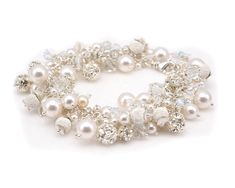 "Bridal Pearl Cluster Bracelet made with Swarovski Pearls and Crystals and hand wire wrapped with sterling silver. Stunning Pearl Cluster Bracelet in Sterling Silver and Swarovski Crystallized Elements™ and sterling silver beads. If you are looking for stunning bling this is the PERFECT bracelet for you! We make this bracelet using white OR ivory (cream) pearls. You can select the color you prefer during check out. More than 175 beads are individually hand wrapped with sterling silver to create White Pearl Bracelet With Silver Beads For Weddings, Pearl Bracelet With Sterling Silver Clasp For Wedding, Sterling Silver Round Crystal Bracelet For Wedding, White Sterling Silver Crystal Bracelet For Wedding, Sterling Silver Round Crystal Wedding Bracelet, Silver Sterling Silver Pearl Bracelet For Wedding, Wedding Bracelets With Silver Beads In Sterling Silver, Sterling Silver Beaded Bracelets For Wedding, Sterling Silver Beaded Wedding Bracelets