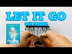 someone is holding a musical instrument in front of a poster with the words let it go