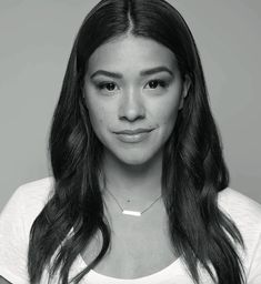 a black and white photo of a woman with long hair wearing a t - shirt