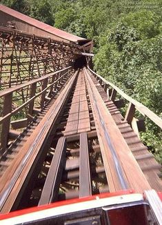 an overhead view of a train track with trees in the background