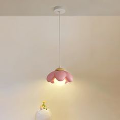 a pink and white lamp hanging from the ceiling