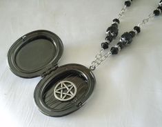 "Hidden Pentacle Necklace This beautiful necklace has black glass beads, silver plated beads, silver plated bead caps, silver plated chain, gunmetal locket pendant with black acrylic setting, pewter silver crescent moon embellishment and a hidden pewter silver pentacle. Very discreet. 20\" long. Sterling silver plated lobster clasp." Jewelry Witchcraft, Moon Locket, Pentacle Jewelry, Witch Pentagram, Pentacle Necklace, Wicca Jewelry, Pagan Necklace, Wiccan Necklace, Pentagram Necklace