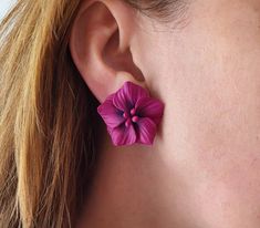 a close up of a person's ear with a flower in the shape of a flower